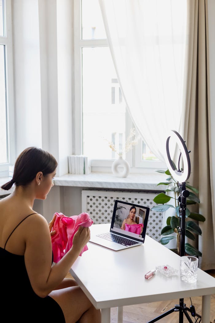 why-choose-us-01 A young woman creates fashion vlog content at home with a laptop and ring light.